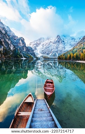 Magical autumn landscape with boats on the lake on Fanes-Sennes-Braies natural park in the Dolomites in South Tyrol, Alps, Italy. (mental vacation, holiday, inner peace, harmony - concept)