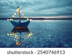 magical blue paper boat with lantern at the beach - romantic evening