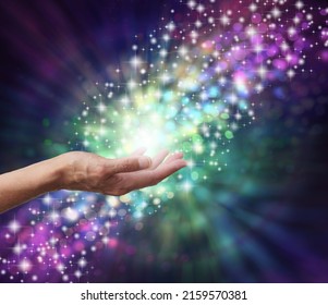 Magical Energy Healing Hands Concept - sparkling and bokeh background with a female open palm in the middle and a stream of multicoloured energy flowing through a subtle spiral 
 - Shutterstock ID 2159570381