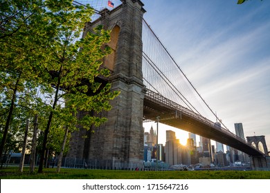 Magical evening sunset close up view of the Brooklyn bridge from the Brooklyn park with a lower Manhattan view on the other side of the Hudson river. - Powered by Shutterstock