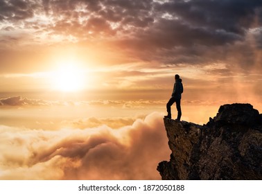 Magical Fantasy Adventure Composite of Man Hiking on top of a rocky mountain peak. Background Landscape from British Columbia, Canada. Sunset or Sunrise Colorful Sky - Powered by Shutterstock