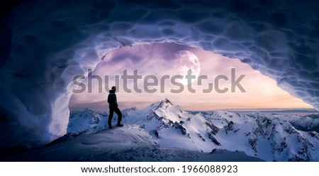 Magical Fantasy Adventure Composite of Man Hiking in an Ice Cave with Winter Mountain Landscape. Colorful Sunset Sky Art Render. Background taken from British Columbia, Canada.