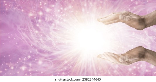 Magical Healing Starlight Healing Energy - Male Reiki Master Healer with parallel hands reaching into white star orb light against beautiful pink energy field background and copy space
