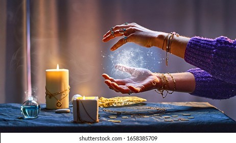 Magical luminous swirling glowing ball in the palm of a witch wizard woman during a witchcraft and occult esoteric spiritual ritual. Magic and sorcery