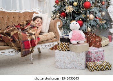 Magical Moment. Christmas Night. Happy New Year. Family Holiday. Christmas Tree And Presents. Dreaming About Gifts. Little Girl Sleep Couch Near Christmas Tree Classic Interior. Believe In Miracles.