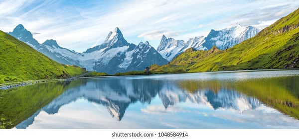 A magical panorama landscape with a lake in the mountains in the Swiss Alps, Europe. Wetterhorn, Schreckhorn, Finsteraarhorn et Bachsee. ( relaxation, harmony, anti-stress - concept). 