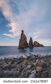 Magical Place Of Ilheu Da Ribeira Da Janela Near The Famous Town Of Porto Moniz In The Northwest Of The Island Of Madeira, Portugal. Long Exposure At Sunset On A Rock Washed By The Ocean.