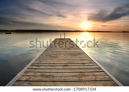 magical place at the lake, romantic evening on wooden jetty at the beach