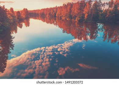 Magical Sunrise Over Lake With Beautiful Reflection On Water. Serene Lake In Early Morning. Nature Landscape