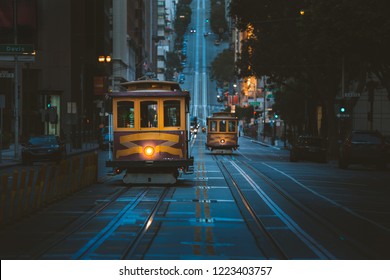 Magical twilight view of historic Cable Cars riding on famous California Street at dawn before sunrise, San Francisco, California, USA