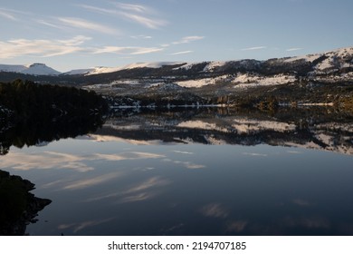 Magical View Of The Andes Mountains, Forest And Blue Sky Reflection In The Lake At Sunrise.