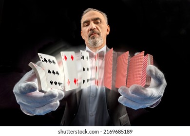 Magician With Cards, Card Manipulation, Croupier Or Casino Dealer At Gambling Club Or Casino. Close Up Of Male Hand With Poker Cards.