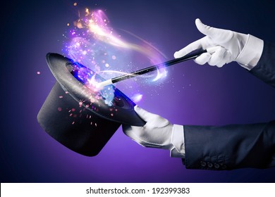 Magician hand with magic wand and hat