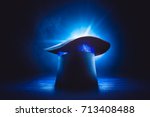 Magician hat on a wooden background with dramatic lighting