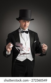 Magician Holding Playing Cards, Showing Focus, Juggles