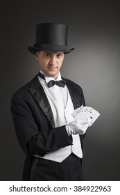 Magician Holding Playing Cards, Showing Focus, Juggles