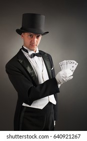 Magician Holding Playing Cards, Showing Focus, Juggles