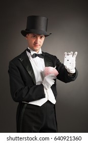 Magician Holding Playing Cards, Showing Focus, Juggles