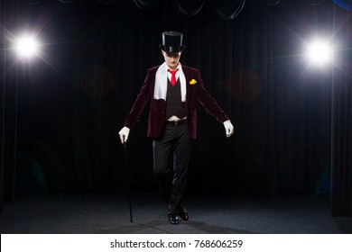 Magician, Juggler Man, Funny Person, Black Magic, Illusion Standing On The Stage With A Cane Of Beautiful Light