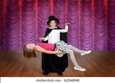 Magician Levitating Assistant On A Stage