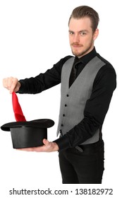 Magician Performing With A Red Handkerchief And Top Hat. Wearing A Black Shirt And Vest. White Background.