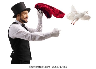 Magician performing a trick and a white dove flying from his hand isolated on white background - Powered by Shutterstock