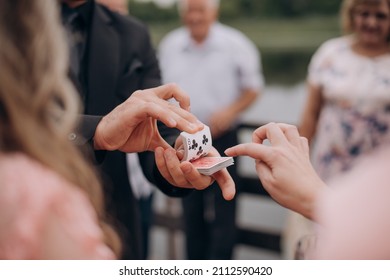 Magician Shows Trick With Cards