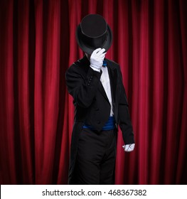 Magician With Top Hat Front Red Curtain On Stage