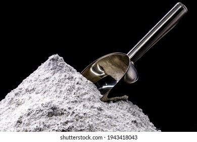 magnesium sulfate on black isolated background with metal spoon