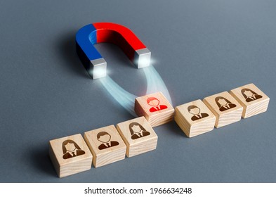 The magnet pulls a red person figure out of the row. Luring concept. Hiring best candidate. Poaching participants from other company. Selection for a management position on a competitive basis.