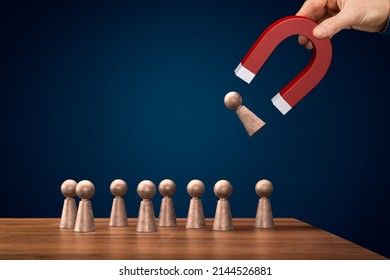 Magnet for your customers, clients or human resources. Marketing and management concepts. Hand of businessman with magnet attract figurine of person. - Shutterstock ID 2144526881