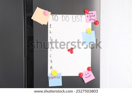 Magnetic board with to do list and notes on refrigerator in kitchen