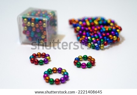 Magnetic colorful balls on the table.Toys for the development of fine motor skills.Magnetic constructor.