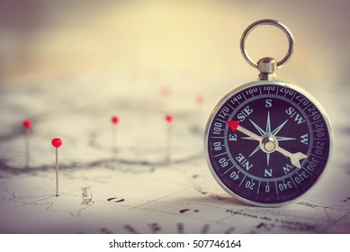 Magnetic compass on a world map conceptual of global travel , tourism and exploration.  Macro photo. - Shutterstock ID 507746164