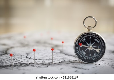 Magnetic compass on a world map conceptual of global travel , tourism and exploration. Macro photo. - Shutterstock ID 511868167