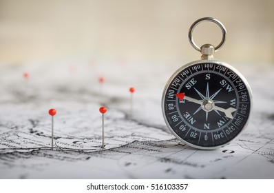 Magnetic compass on a world map conceptual of global travel , tourism and exploration. Macro photo. - Shutterstock ID 516103357