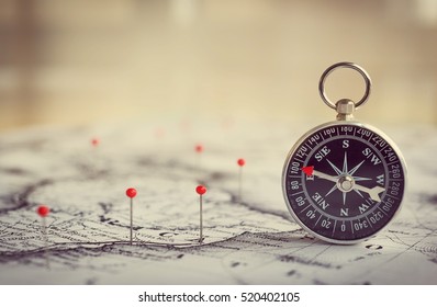 Magnetic compass on a world map conceptual of global travel , tourism and exploration. Macro photo. - Shutterstock ID 520402105