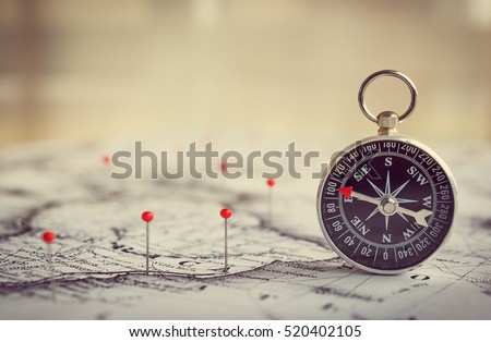 Magnetic compass on a world map conceptual of global travel , tourism and exploration. Macro photo.