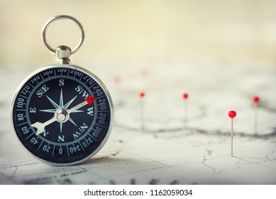 Magnetic compass on world map.Travel, geography, navigation, tourism and exploration concept background. Macro photo. Very shallow focus. - Shutterstock ID 1162059034