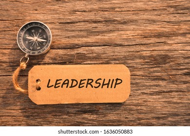 Magnetic compass and text LEADERSHIP written on paper tag at outdoor. Conceptual image with selective focus - Shutterstock ID 1636050883