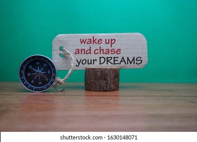 Magnetic Compass And Words Wake Up And Chase Your Dreams Written On Paper, Motivational And Creative Concept.