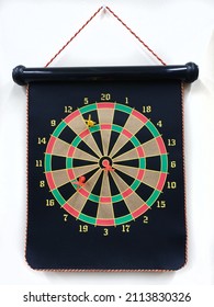 Magnetic Dartboard With Darts Hanging From White Office Wall.