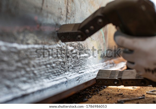 Magnetic field\
test steel tank butt weld overlay carbon shell plate of storage\
tank oil background white\
contrast