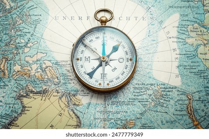 Magnetic old compass and rope on old nord pole map. Travel, geography, history, navigation, tourism and exploration concept background. Retro compass on geography map. - Powered by Shutterstock