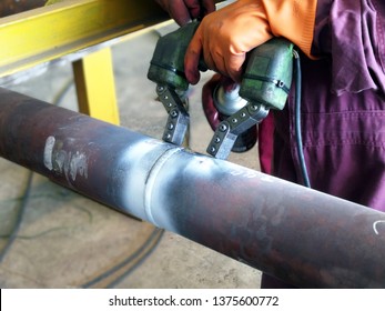Magnetic particle inspection for weld joint of piping by Magnetic Yoke portable electrical method  - Shutterstock ID 1375600772