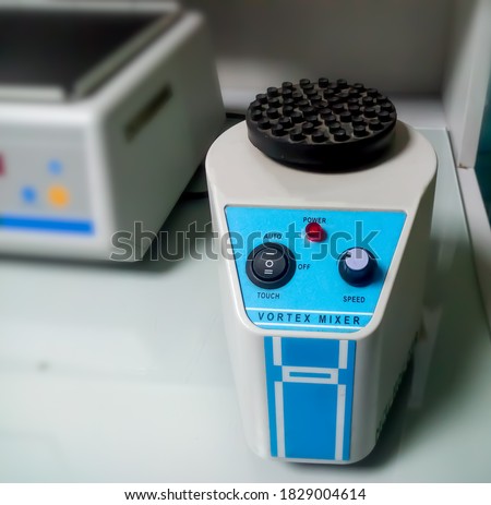 A magnetic vortex or magnetic mixer isolated in serology department/PCR lab. Digital Rotator. Closeup.