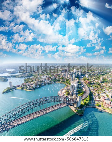 Magnificence of Sydney Harbor at sunset, aerial view from helicopter.