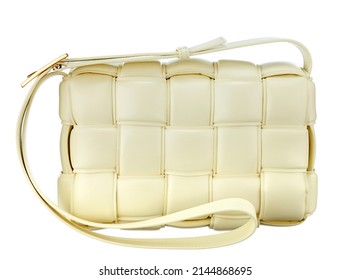 Magnificent bag made of cream-colored braided leather, with a strap-harness for carrying on the shoulder, isolated on a white background. Expensive women's accessories. High quality photo.