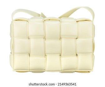 Magnificent bag made of cream-colored braided leather, with a strap-harness for carrying on the shoulder, isolated on a white background. Front view. Expensive women's accessories.
