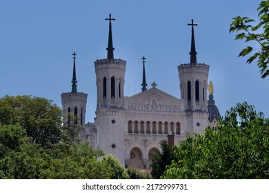 Magnificent Basilica of Our Lady of Fourvière in summer emerging from the vegetation in Lyon, France